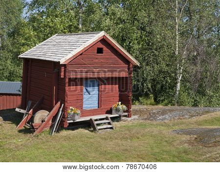 Red cabin, warehouse on a yard.