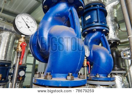 Closeup of manometer, pipes and faucet valves of gas heating system in a boiler room