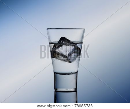 Short Drink Glass With Clear Liquid And Ice Cubes