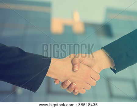 Handshake Handshaking and blured building in background