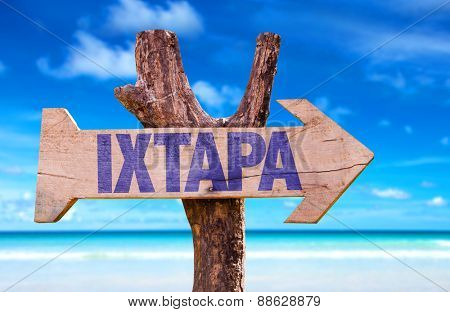 Ixtapa wooden sign with beach background