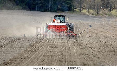 Valmet 8550 Tractor And Seeder On Field At Spring