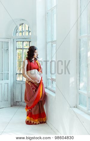 The pregnant woman belly with henna tattoo