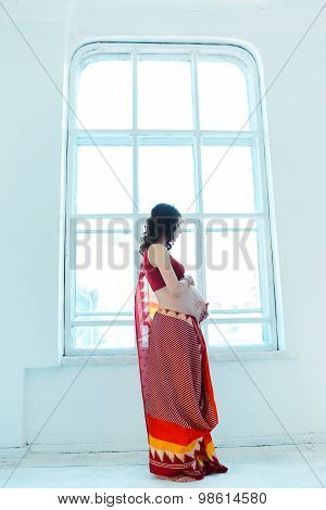 The pregnant woman belly with henna tattoo