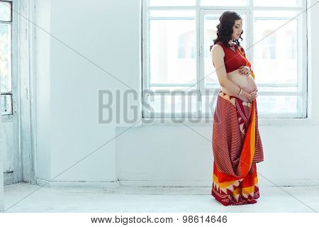 The pregnant woman belly with henna tattoo