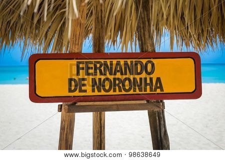 Fernando de Noronha sign with beach background