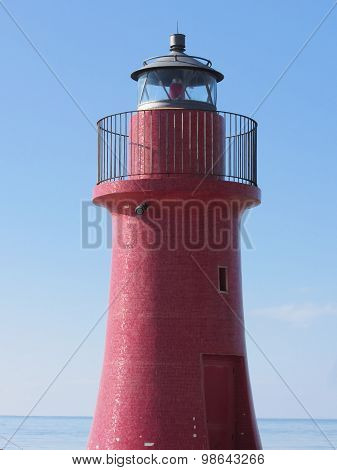 A View Of The Red Harbor Lighthouse Along The Tuscany Coastline In Castiglione Della Pescaia, Italy