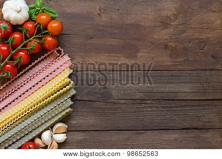 Mafalde Pasta, Olive Oil, Garlic And Tomatoes On The Wooden Table