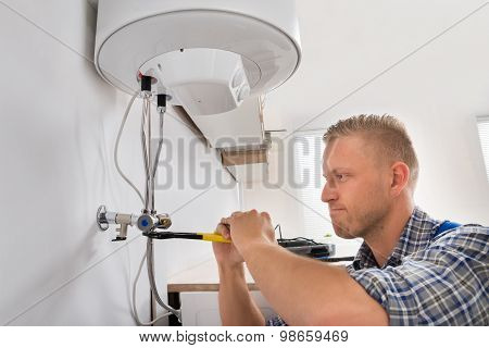 Repairman Repairing Electric Boiler