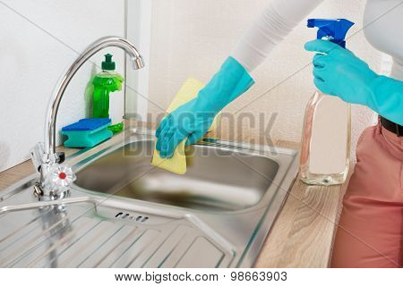 Woman Wiping Kitchen Sink