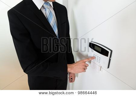 Businessman Setting Home Security Alarm System