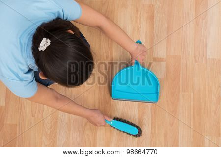 Woman Brooming Wooden Floor