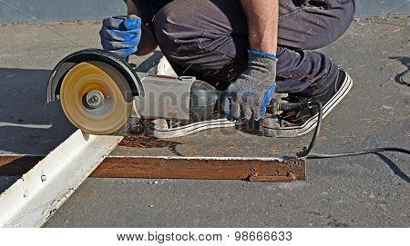 Hands Of The Mechanic Working With The Angular Grinder
