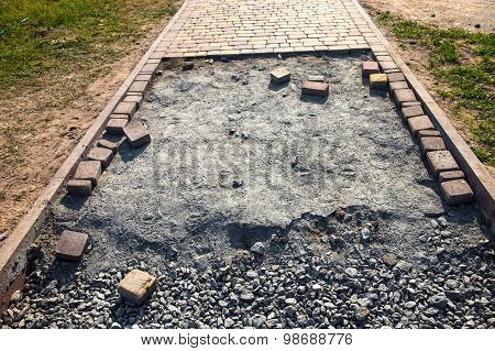 Paving The Footpath With The Tiled Cubes.