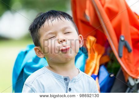 Small kid showing his tongue to make a funny face