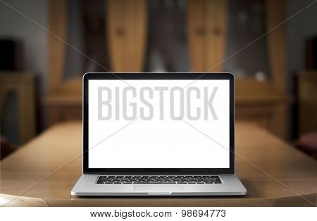 Notebook with blank screen on table.