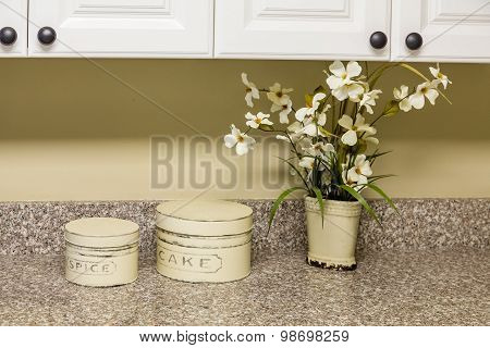 Tins And Flowers On Kitchen Counter