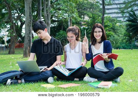 Young Student Asian Group Teenager with school folders on grass at university campus college
