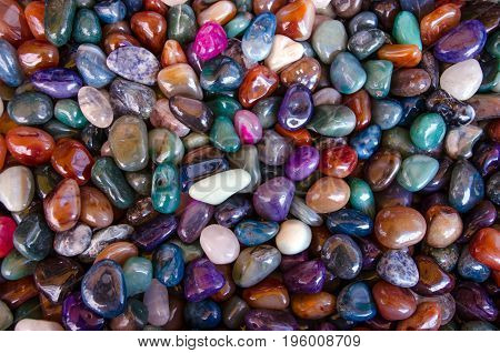 Happiness stones. Full frame colorful polished gemstones background. Close-up.