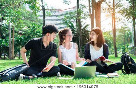 Young Student Asian Group Teenager with school folders on grass at university campus college
