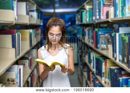 Young Student Girl Reading Book in Classroom Education Library