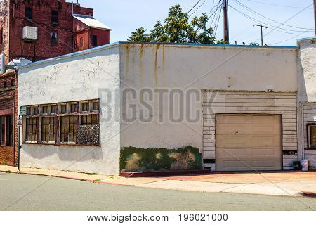 Abandoned Building In Disrepair With Boarded Up Windows