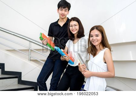 Young Student Group Holding Book and Laptop Computer Smile in Classroom Education Library University