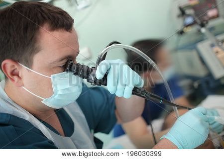 Male doctor undertake an examination to a patient.