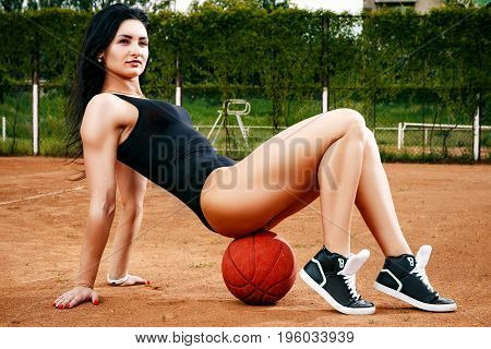 A Beautiful Young Free Sports Sexy Girl Dressed In Bodysuit, Sneakers, With A Smart Ass And Long Leg