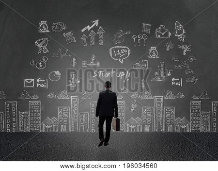 businessman and business plan concept on wall