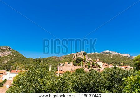 The Mountain Town Of Pratdip In Spain. Copy Space For Text. Isolated On Blue Background.