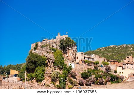 The Mountain Town Of Pratdip In Spain. Copy Space For Text. Isolated On Blue Background.