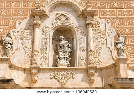 Bas-reliefs and sculptures on the facade of the church Santa Maria Assumpta in Les Borges del Camp Tarragona Catalunya Spain. Close-up