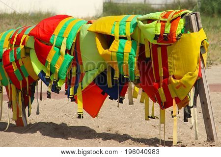 Colorful Life Jackets Save Your Life. Safety In Water. Rescue Service On The Beach. Injuries To Wate
