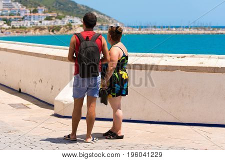 Man And Woman On The Background Of The Sea. Back View. Copy Space For Text.
