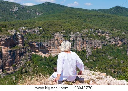 Girl on the rock in Siurana de Prades Tarragona Catalunya Spain