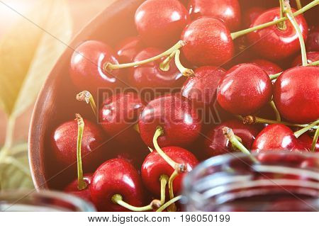 Cherry jam on wooden ground with fresh cherries