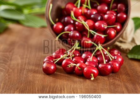 Cherries on wooden table with water drops macro background