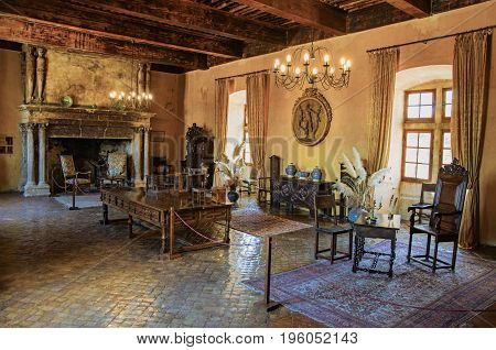 Lourmarin, France - July 07, 2016. Decoration with fireplace in hall in Lourmarin castle. In the Vaucluse department, Provence-Alpes-Côte d'Azur region, southeastern France