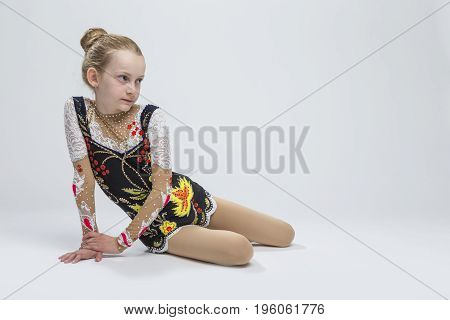Sport Ideas. Young Caucasian Female Rhythmic Gymnast Athlete In Professional Competitive Suit Posing in Studio Against White.Horizontal Image