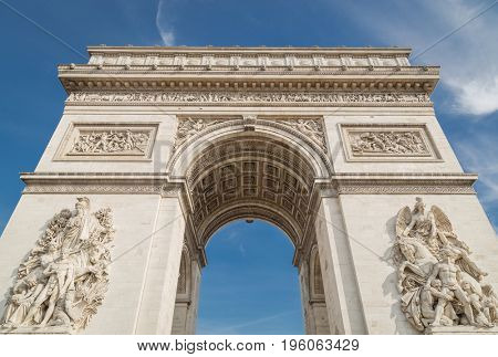 Arc de Triomphe in Paris under sky with clouds
