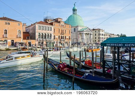 VENICE,ITALY- May 18, 2017. Tourists on water street with Gondola in Venice. its entirety is listed as a World Heritage Site, along with its lagoon