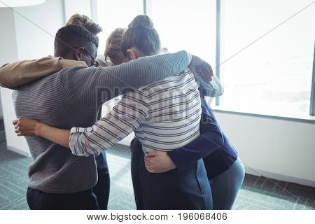Business colleages huddling together at office