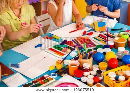 Child dough play in school. Plasticine for children. mold from plasticine in kindergarten .Cropped of kids knead modeling clay with hands in preschool.