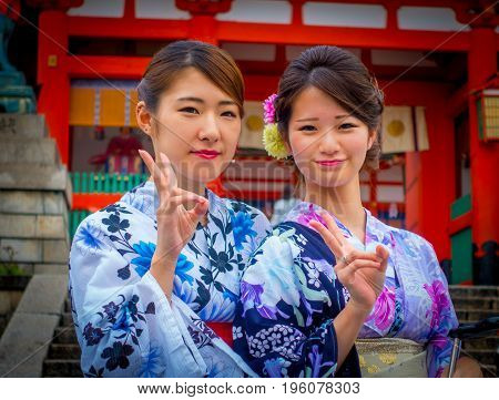 KYOTO JAPAN - NOVEMBER 24, 2016: Close up of tourists visit fushimi inari temple at rainy day in Kyoto, Japan.