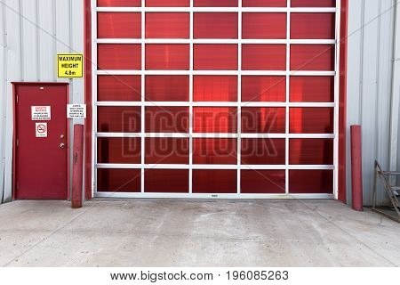An image of a large red industrial baydoor.