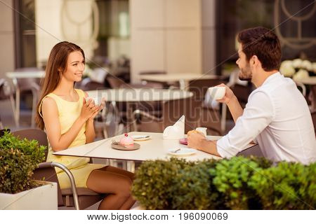 Yummy Morning. Two Cute Lovers Are Sitting In Light Cafe On A Sunny Day And Enjoy Coffee With Tasies