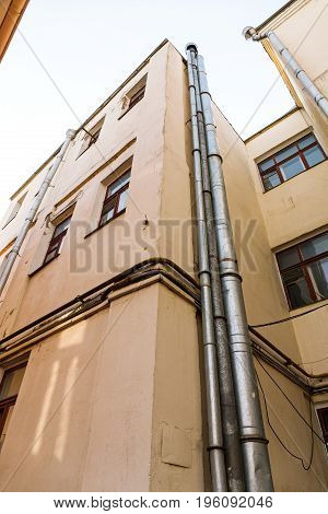 Old Apartment Buildings On Blue Sky Background. View From Bottom.