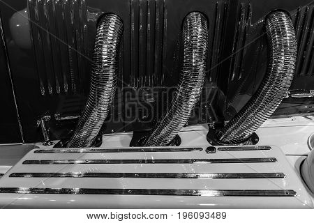 STUTTGART GERMANY- MARCH 19 2016: Exhaust system of luxury car Mercedes-Benz Typ SS (Super Sport) 1930. Black and white. Mercedes-Benz Museum.