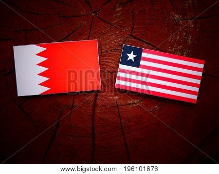 Bahraini Flag With Liberian Flag On A Tree Stump Isolated